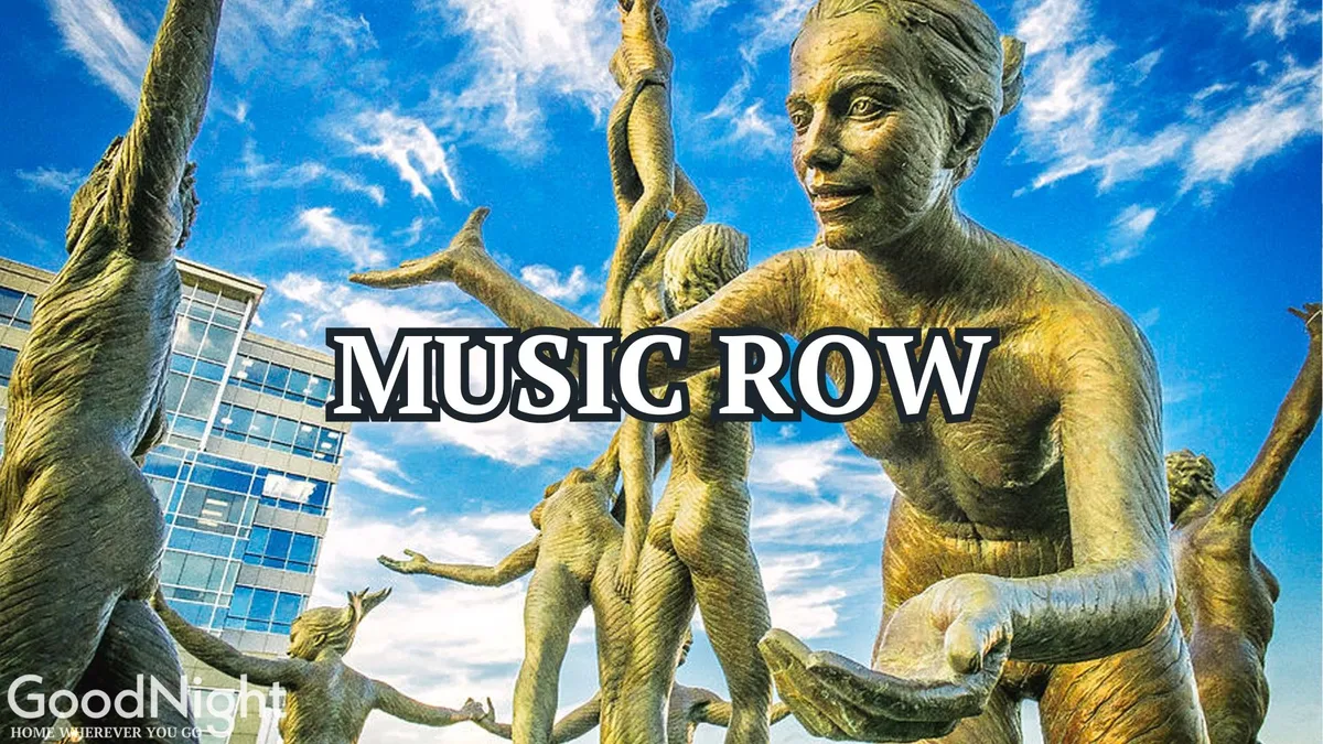 A lively exterior view featuring bronze sculptures, a modern building beneath a blue sky, and people engaging in cultural exploration. The scene represents public art and the celebratory atmosphere that defines Nashville’s downtown.